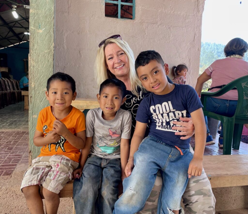 Saving Grace team member with children in Honduras